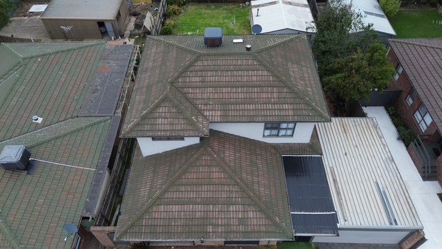 Before: roof restoration. Moss and lichen gone, the whole roof coated charcoal.