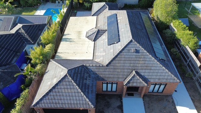 Before: roof restoration. Faded sections brought back to an even charcoal.