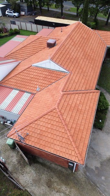 After: roof restoration. Faded terracotta restored in fresh terracotta.