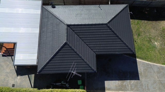 After: roof restoration. Repointed first, then coated charcoal.