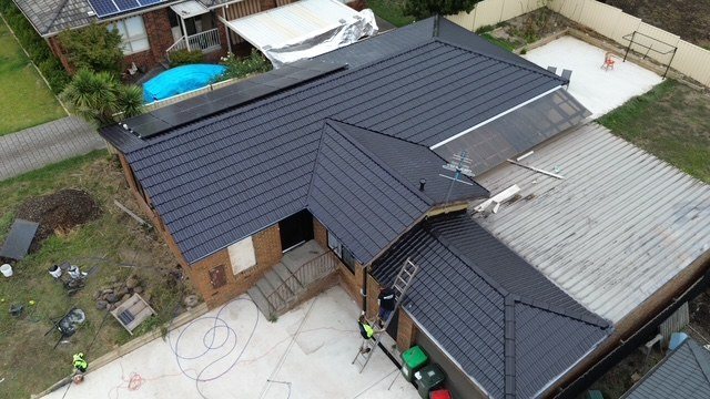 After: roof restoration. Brown tiles restored to charcoal.