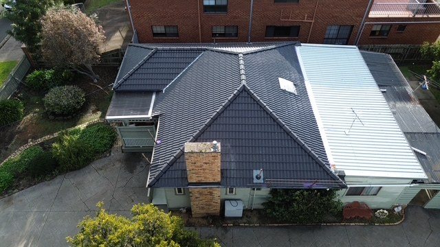 After: roof restoration. Dirty, faded tiles restored to charcoal.