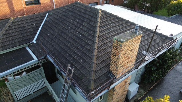 Before: roof restoration. Dirty, faded tiles restored to charcoal.