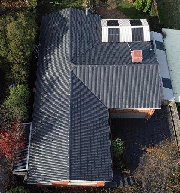 After: roof restoration. Patchy, mismatched tiles finished in one colour.