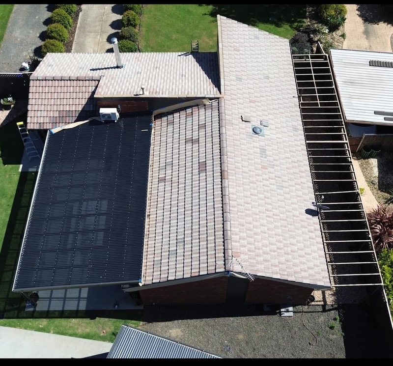 Before: roof restoration. A two-tone roof brought back to one even charcoal.