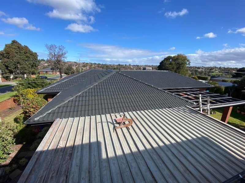 After: roof restoration. Terracotta tiles restored and recoloured charcoal.