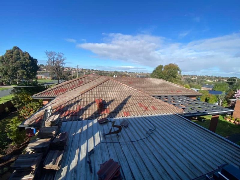 Before: roof restoration. Terracotta tiles restored and recoloured charcoal.