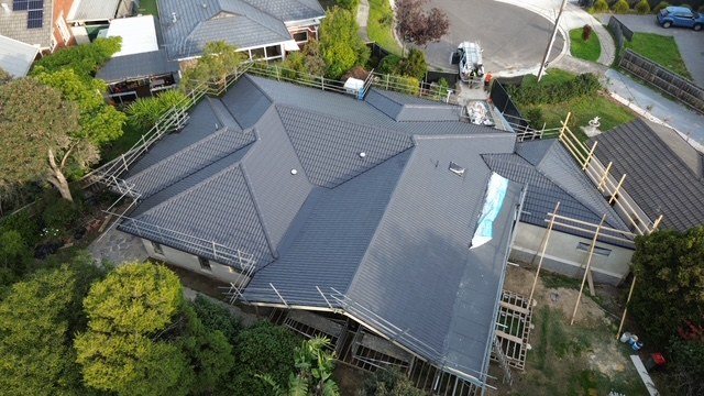 After: extension and new roof. Framed, sarked and tiled, with the existing roof tied in.