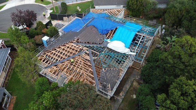 Before: extension and new roof. Framed, sarked and tiled, with the existing roof tied in.
