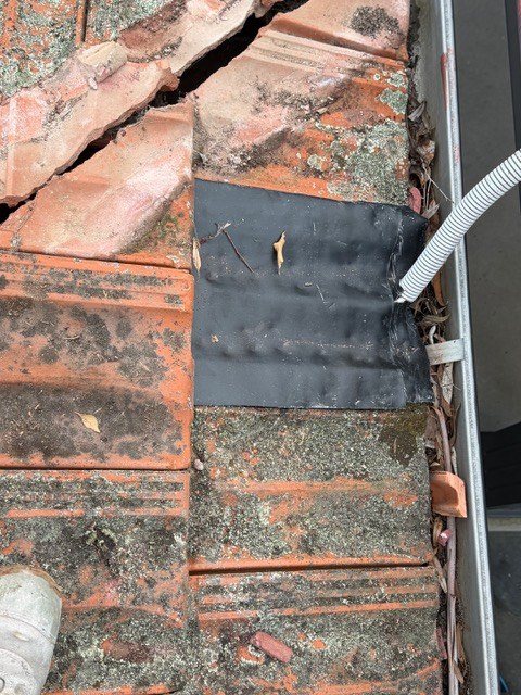 After: leak repair. Damaged flashing and broken tiles repaired and sealed.
