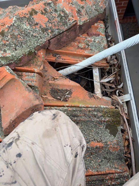 Before: leak repair. Damaged flashing and broken tiles repaired and sealed.