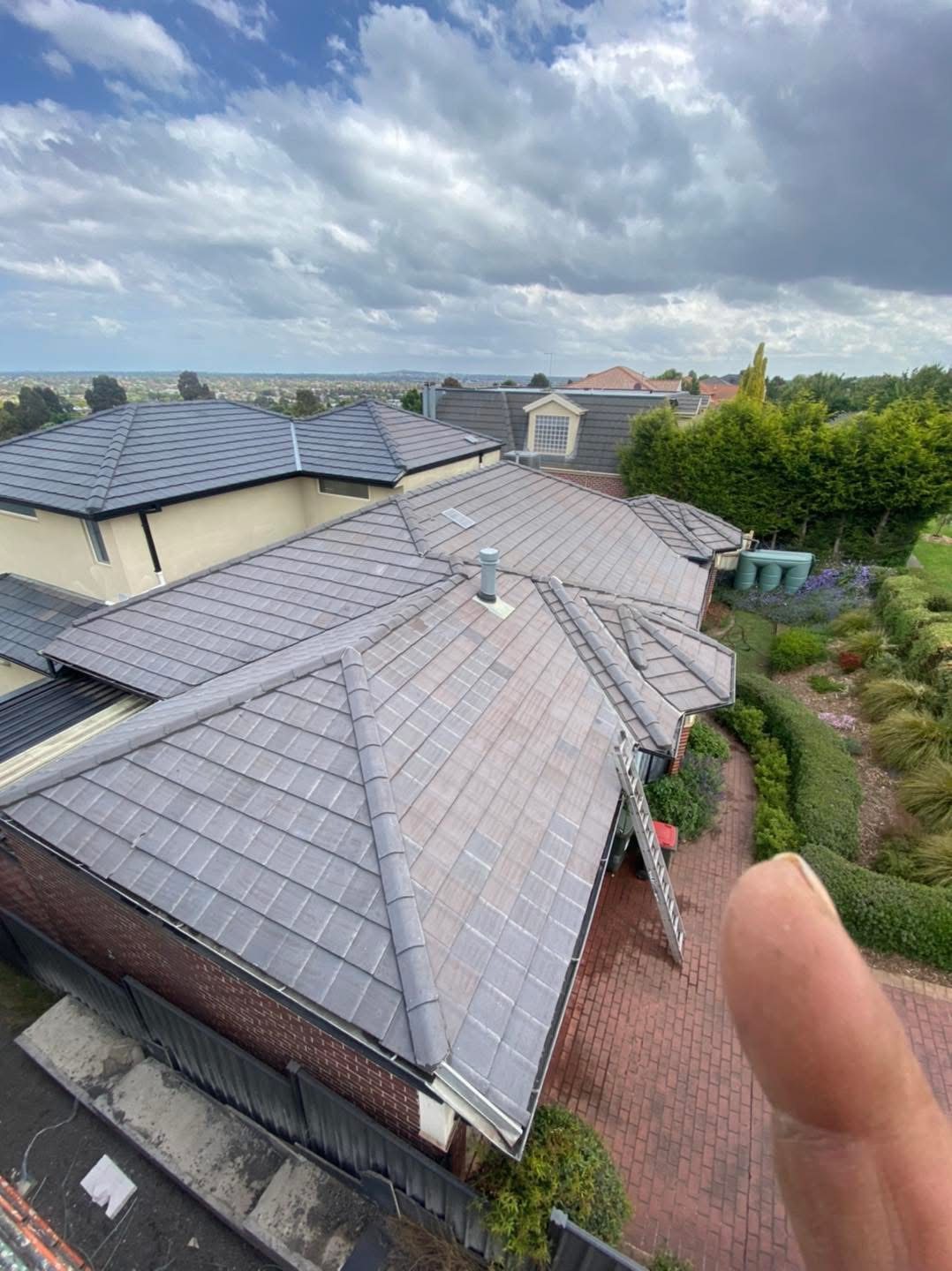 A freshly restored grey tile roof seen from the ridge